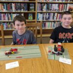 Lego Club participants show off their creations.